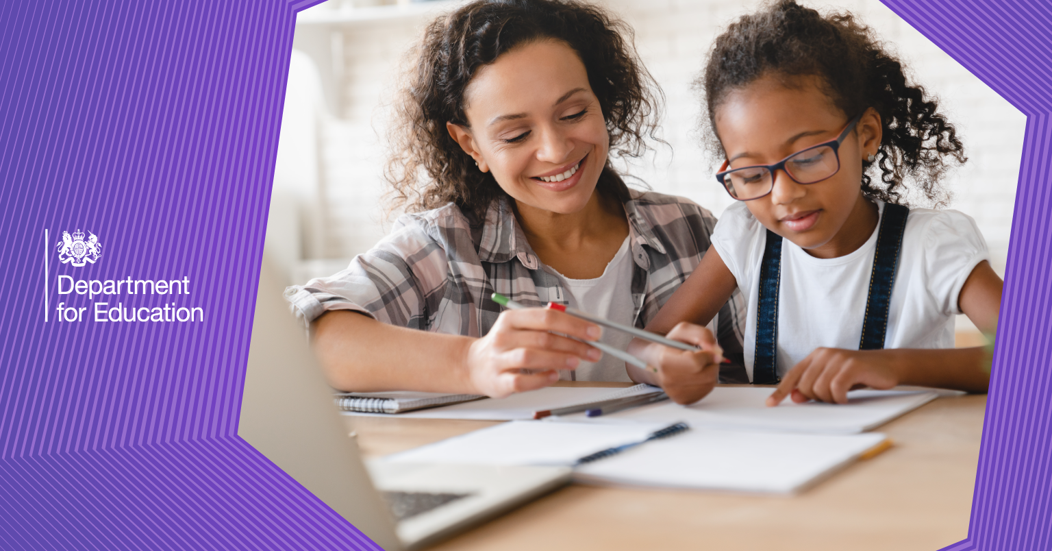 Childminder and child working at a desk