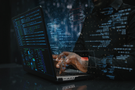 Hands of male sitting in front of computer