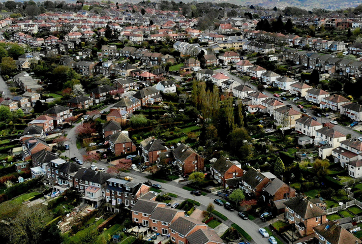 Image of houses on a UK street.
