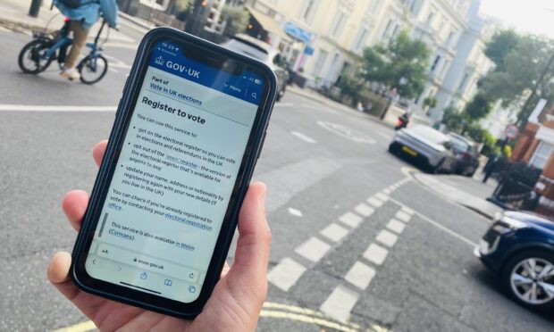 A mobile phone showing the register to vote page on GOV.UK