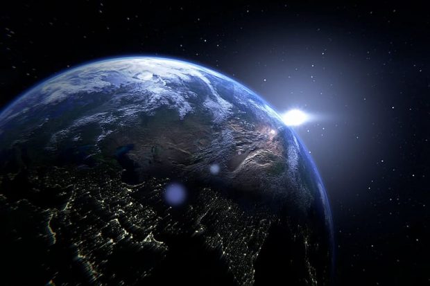 image shows earth with a flash of light behind