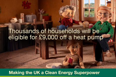 Three people in the kitchen of a family home - the characters and furnishings are all made of knitted materials, as the image has been taken from a stopmotion campaign video. Text says "Thousands of households will be eligible for £9,000 off a heat pump"