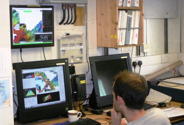 UKHO mapping expert Dan Evans monitoring incoming data. Image credit: Vlad Laptikhovsky, Cefas