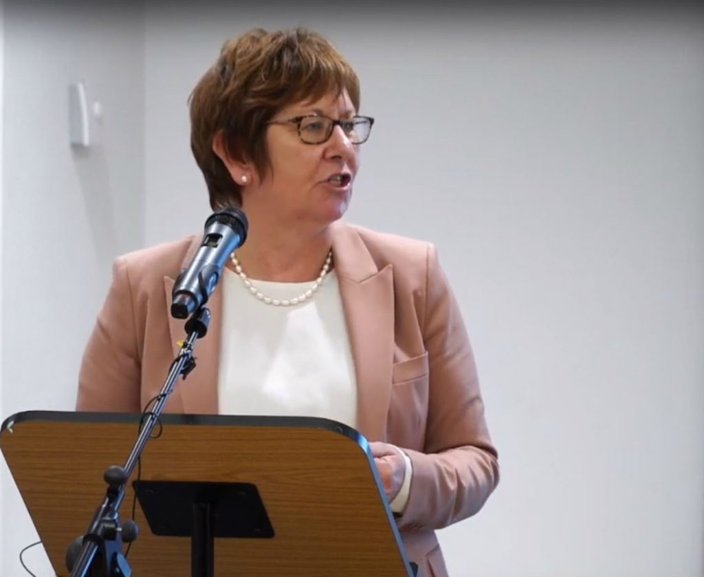 Bernadette Kelly speaking at a lectern