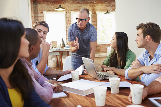 A group of people at a table having a discussion.