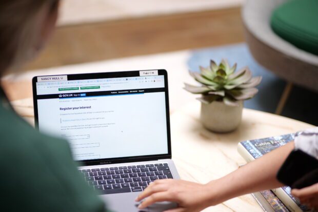 Person viewing GOV.UK Sign In product website page on a laptop