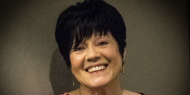Gill Phillips, breast cancer survivor, smiling at the camera