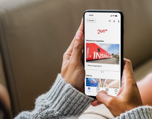 Phone in hand with Railway 200 tour app showing