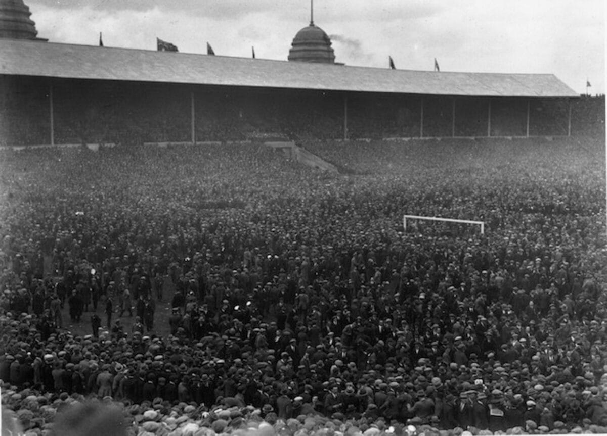 A crowd spilling on to the Wembley pitch during the 1923 FA Cup final between West Ham United and Bolton Wanderers