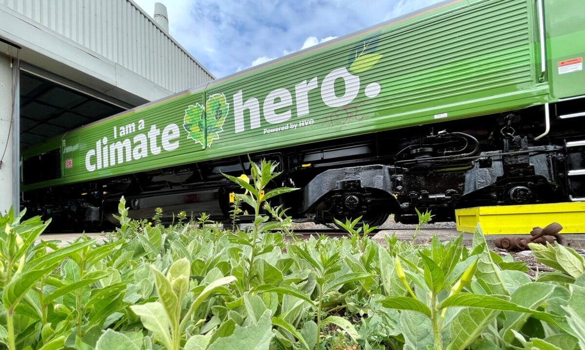 A large green train with 'I am a climate hero' written on the side
