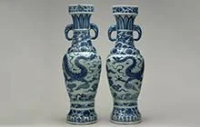 Two identical porcelain vases with blue details including dragon.