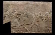 Large relief with men pulling a horse