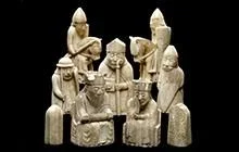 Seven white chess pieces