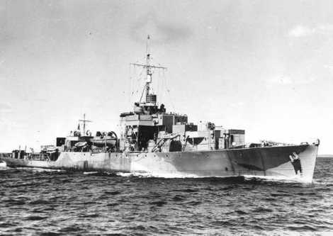 Historic black & white photograph of a warship in starboard broadside view.