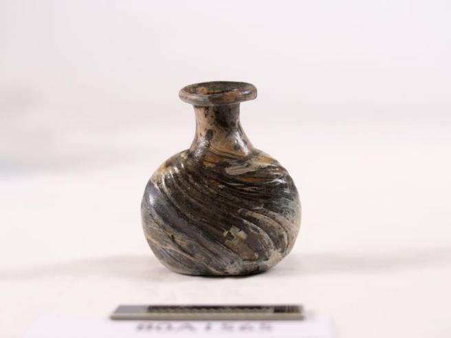 Rounded bottle with scale rule in foreground.
