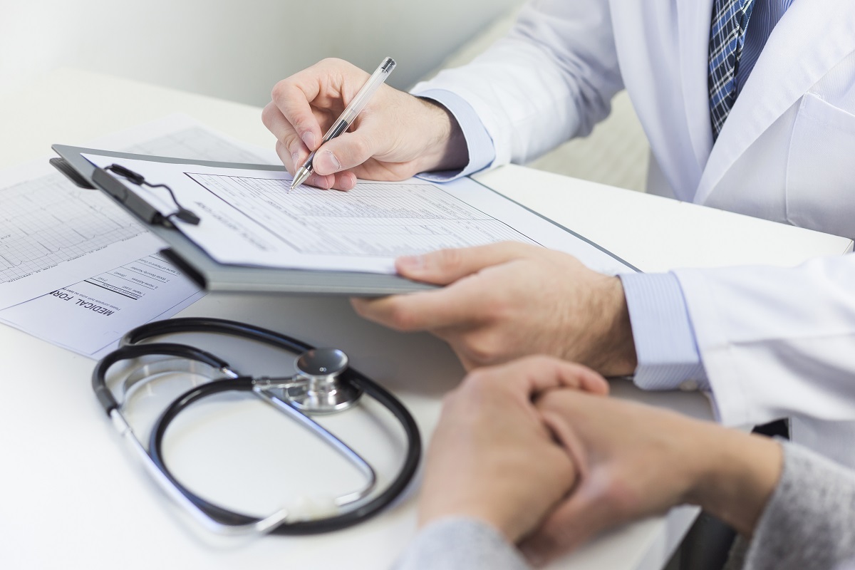Doctor writing notes on a clipboard