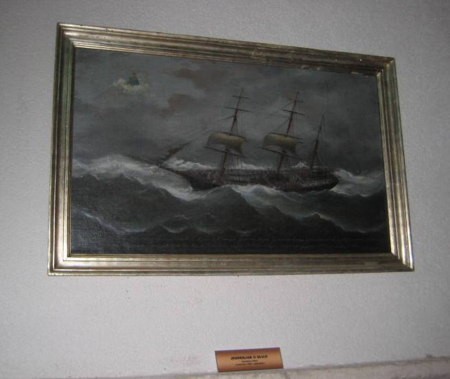 'Sailing ship in a storm', Ivankovic, 1887, ex voto painting in the cloisters at Kuna Peljeska, Croatia. Note the small saint on a cloud towards top left, rendering divine assistance, typical of such scenes, while the ship wallows in the sea, having lost most of her sails. The associated church contains many silver ex voto plaques, many with shipwreck scenes.