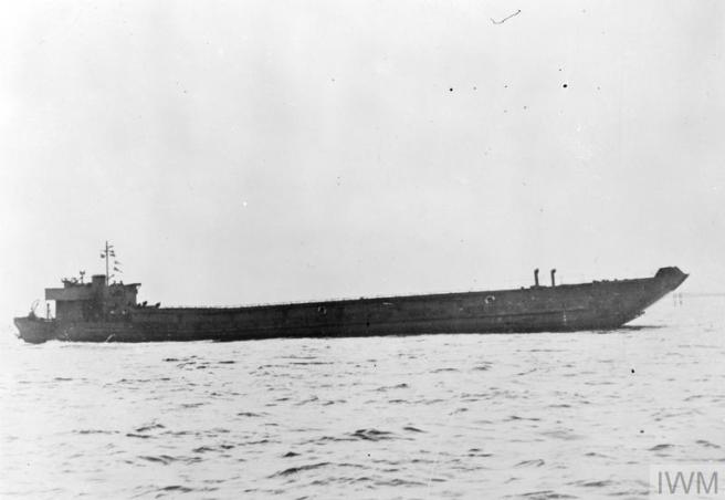 Historic B&W photograph of Landing Craft Tank in port profile view (bows left, stern right)