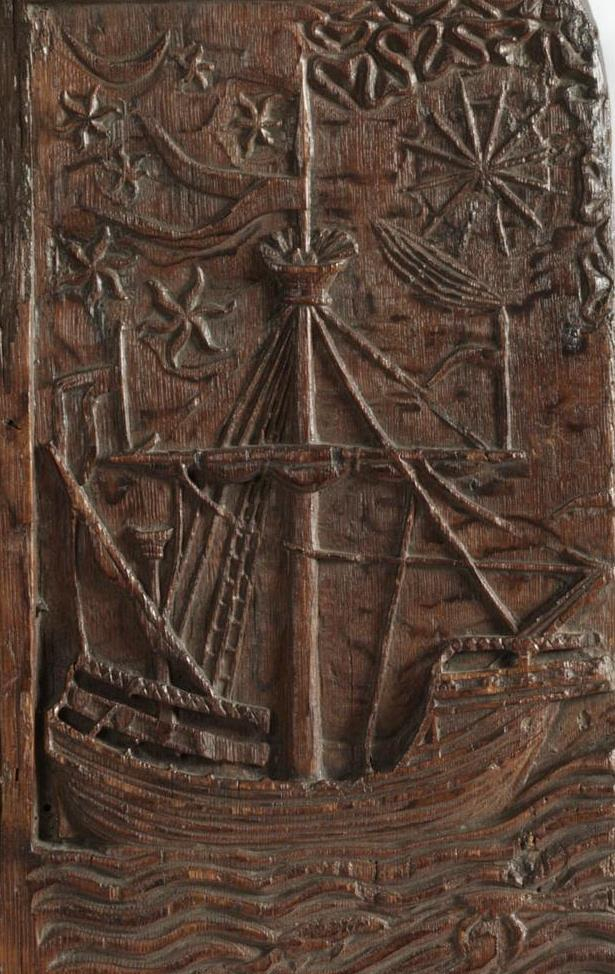 Wood carving of a medieval ship seen broadside on, on a wavy sea, with a tall mast and sunrays to top right.