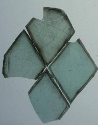 Four broken diamond-shaped panes of glass.