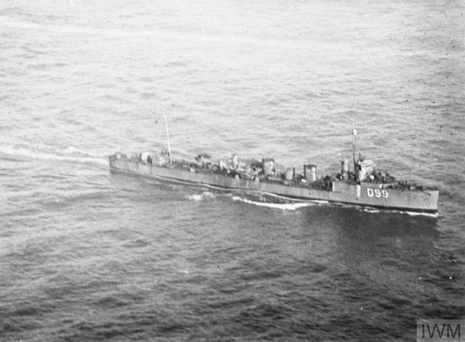 Black and white photograph of warship at sea in the lower half of the photograph, seen in starboard view, bows towards the right of the image.