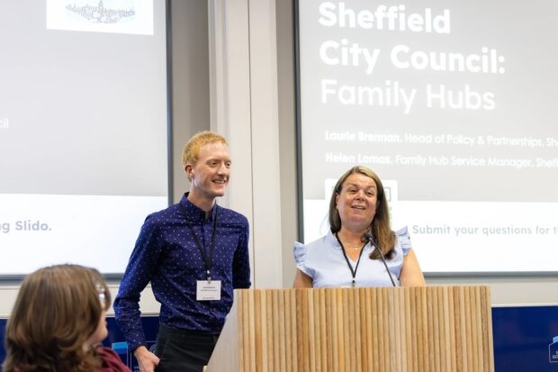 Two members of the Sheffield demonstrator pilot team, Laurie and Helen presenting on family hubs at our first Test, Learn and Grow event. Laurie and Helen are standing next to each other at a podium smiling while mid presentation.