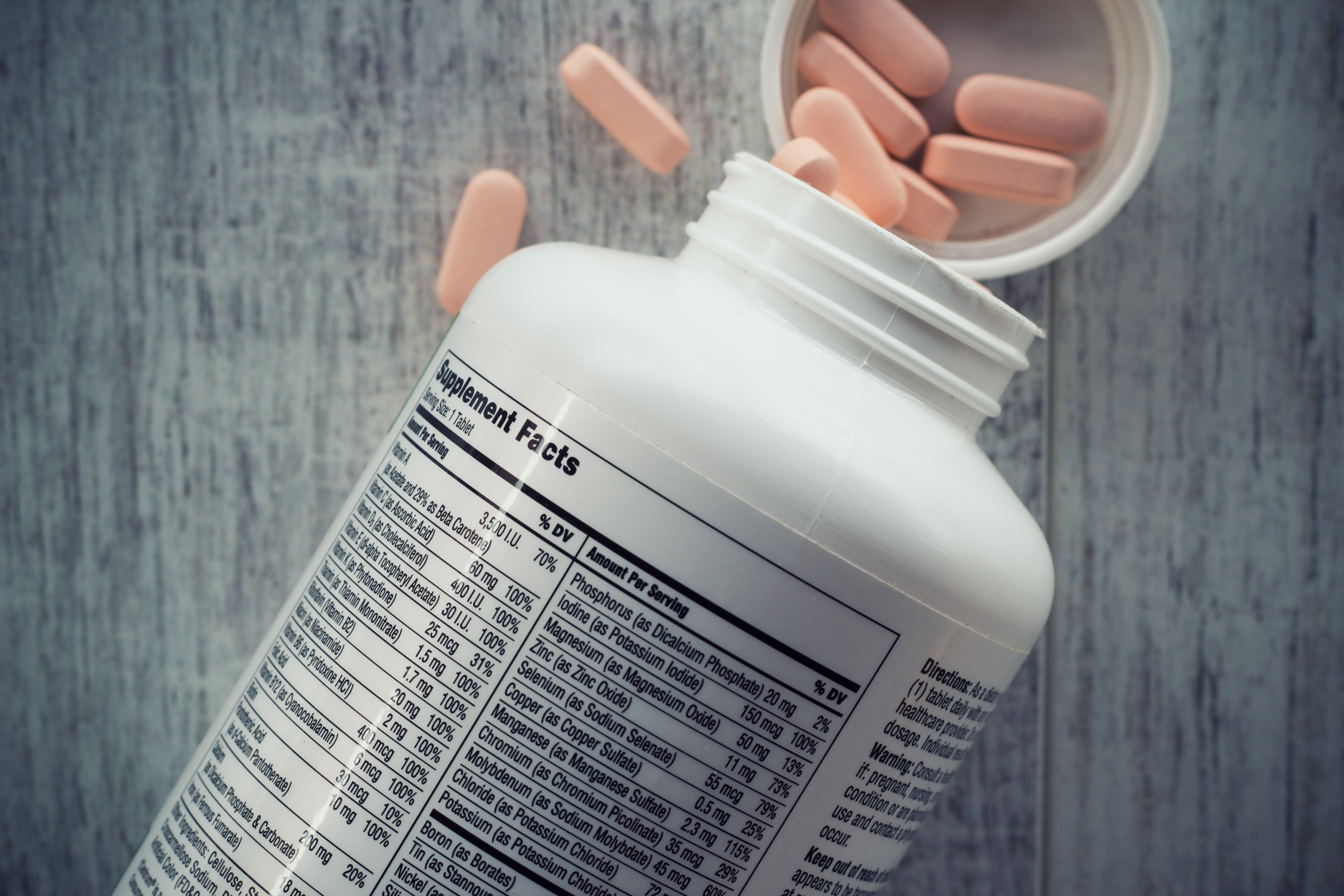 Pills pouring out of a container