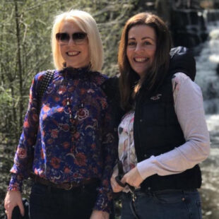 Zoe (left) and Nina (right) in front of a waterfall