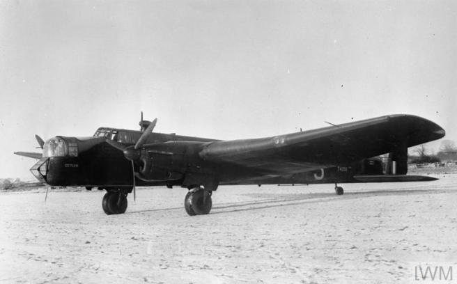 Historic black & white photograph of aircraft on the ground, nose to left of image.