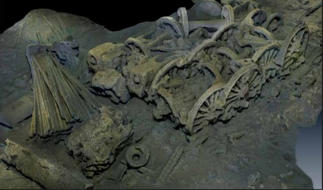 A modern colour 3D scan of a shipwreck showing railway wheels and machinery, covered in sediment.