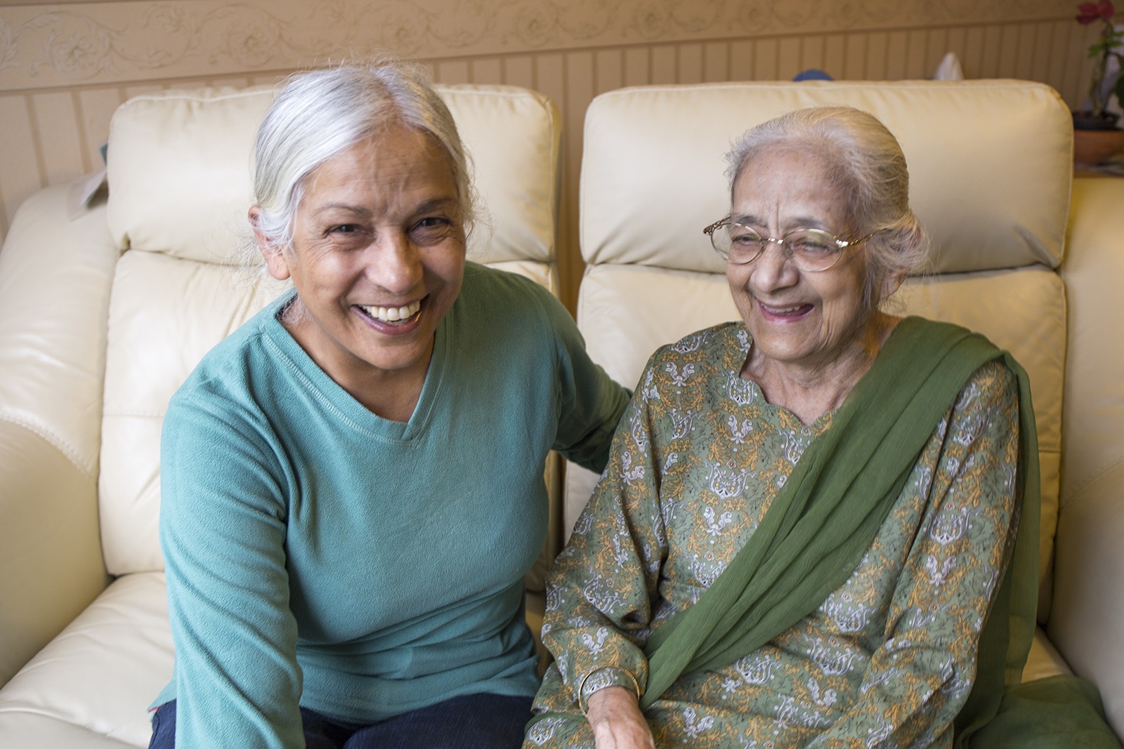 Two ladies sat on a sofa