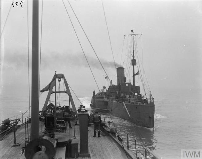 Black and white photograph taken from a steamer at sea showing another paddle steamer beyond and on the right.
