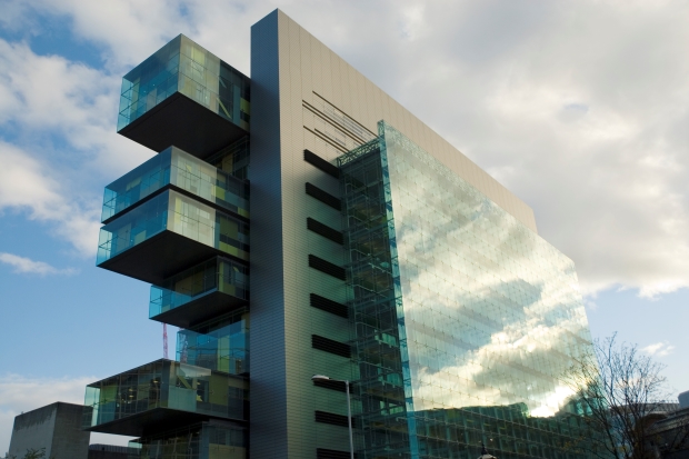 The outside exterior of the Manchester Civil Justice Centre. A modern glass building.