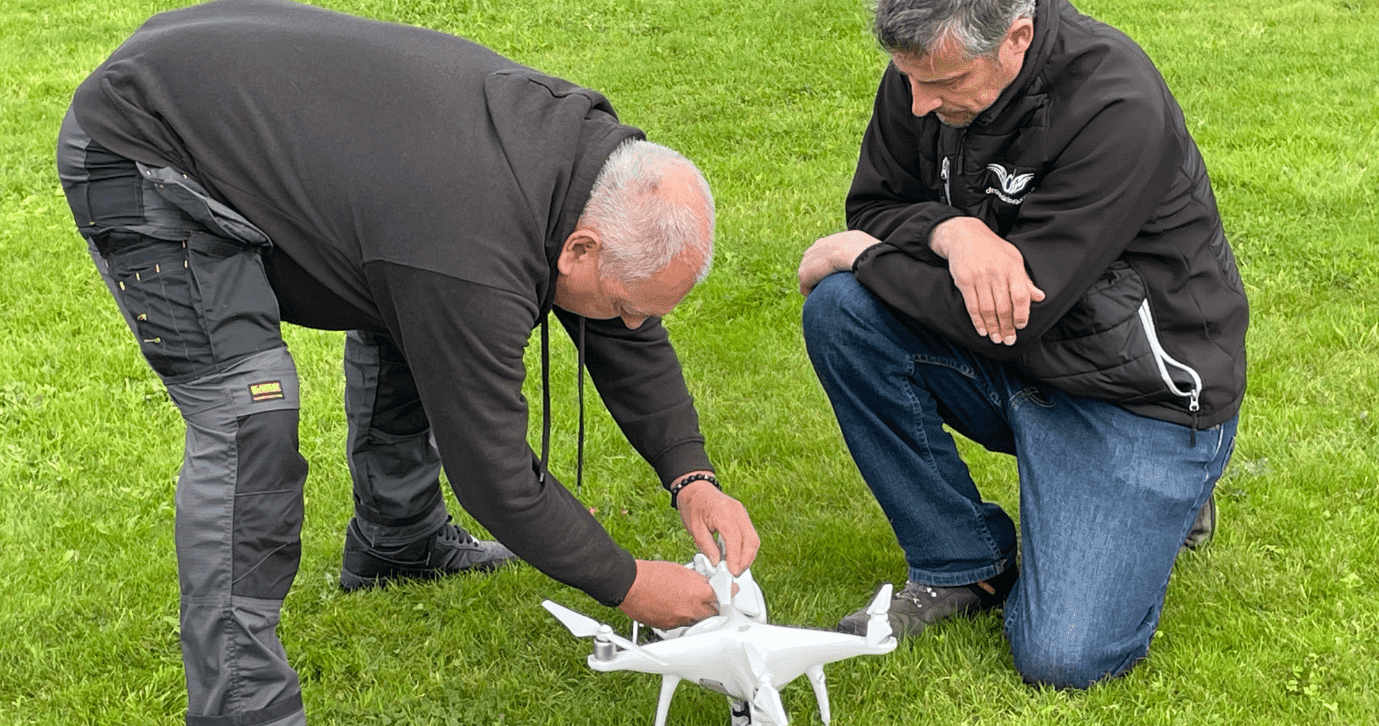 Julian Hoile With Global Drone Training Director Jonathan Carter Inspecting A Drone