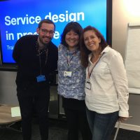 Picture of Martin Jordan, Clara Greo and Emma Thomas in front of Service design training slide