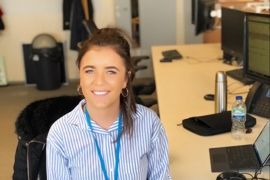 Industrial placement student Jess Johnson sitting at a desk with laptop
