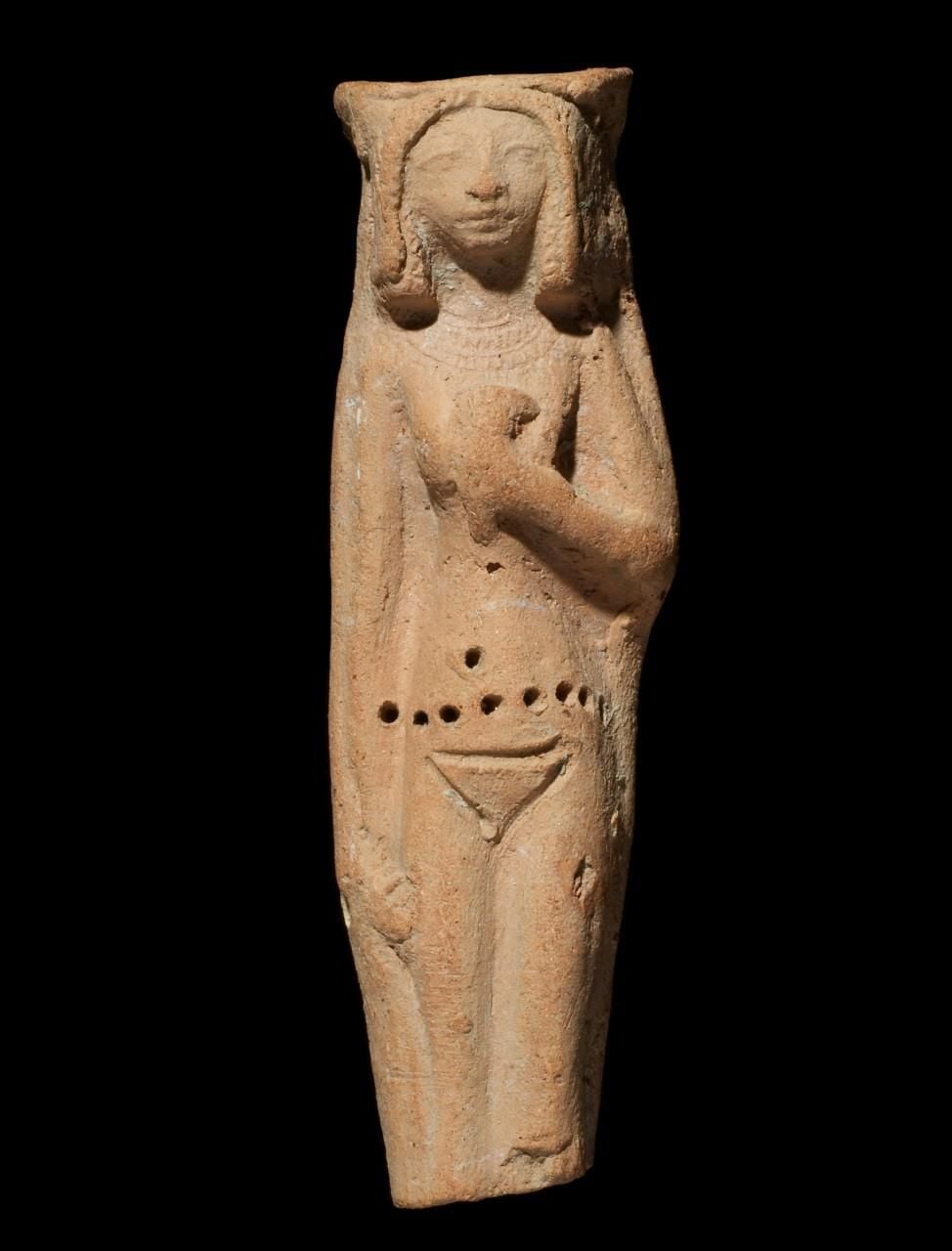 Unglazed pottery figure, female with face of Hathor, kerchief in left hand and wearing headdress.
