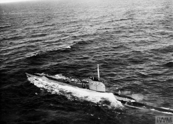 Historic B&W photograph of submarine on the surface of an otherwise empty sea.