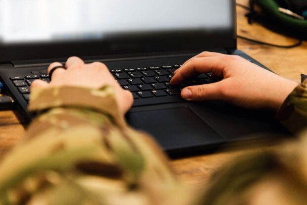 soldier typing on a laptop