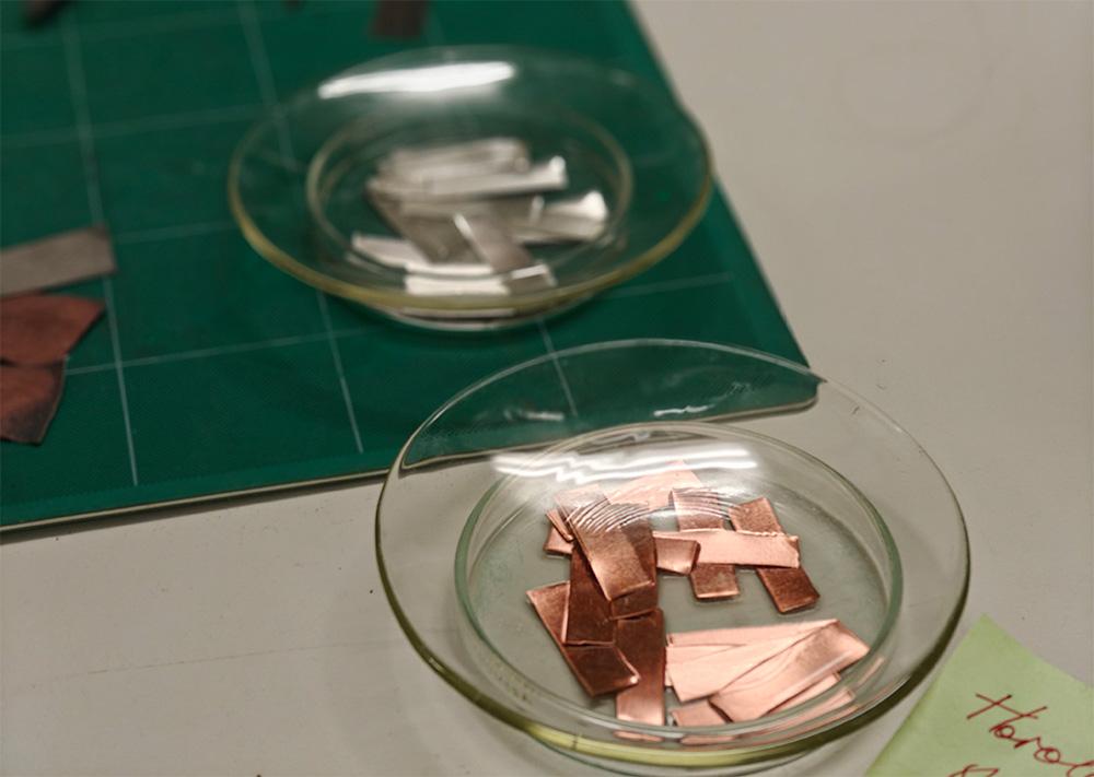 Metal strips in shallow glass dishes