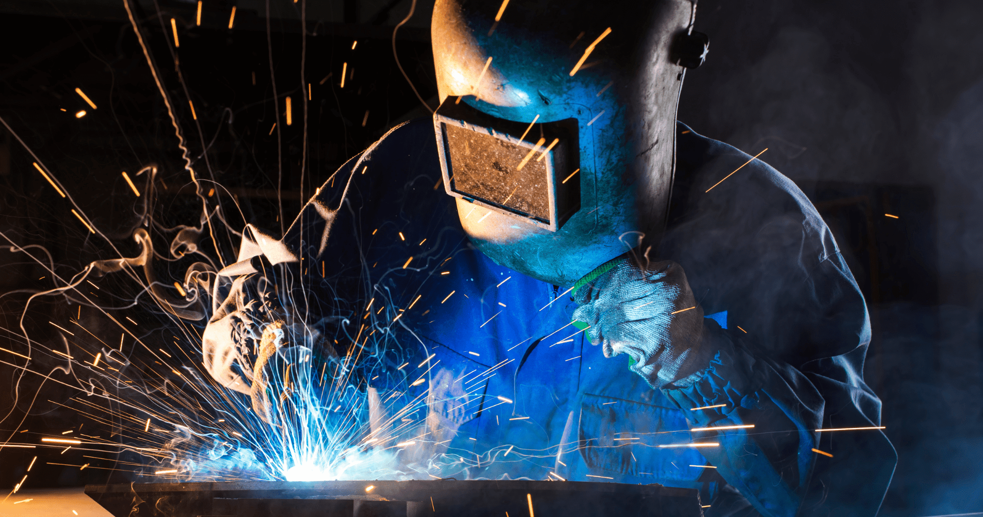 Welding training and welding qualifications can help people like this Person In PPE Welding In A Dark Room