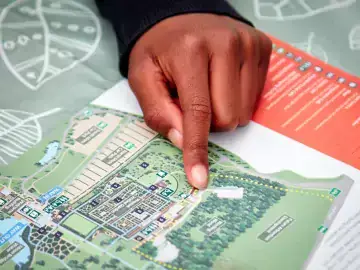 Hand pointing to a map