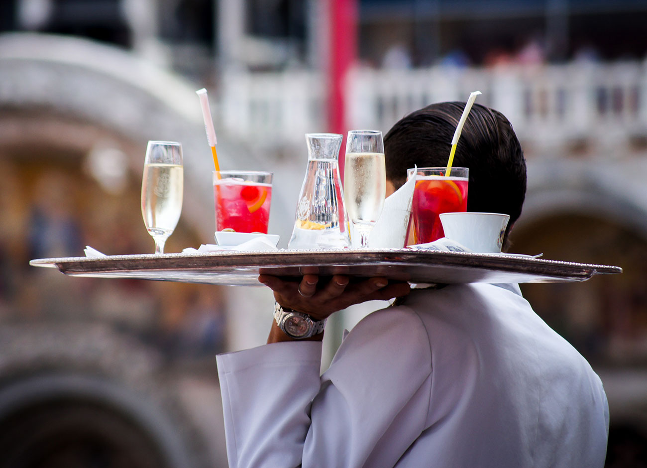 Waiter carrying a tray of drinks