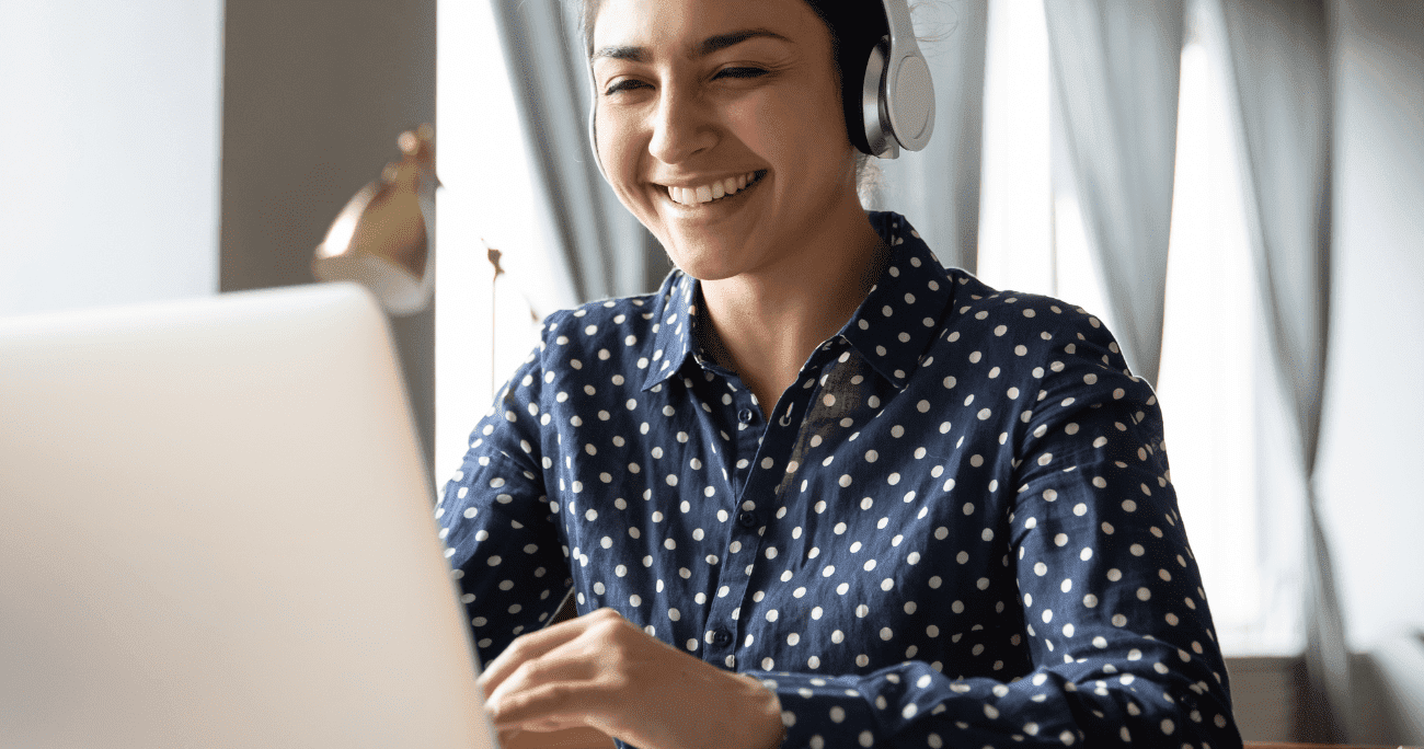 Woman Wearing Headphones Working On A Laptop