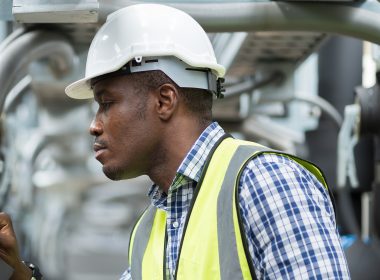 Male Plumber Engineer Worker Work With Digital Tablet In Sewer Pipes Area At Construction Site. African American Male Engineer Worker Check Or Maintenance Sewer Pipe Network System At Construction Sit