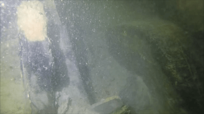 The remains of a wooden gun carriage truck in poor visibility in the Thames