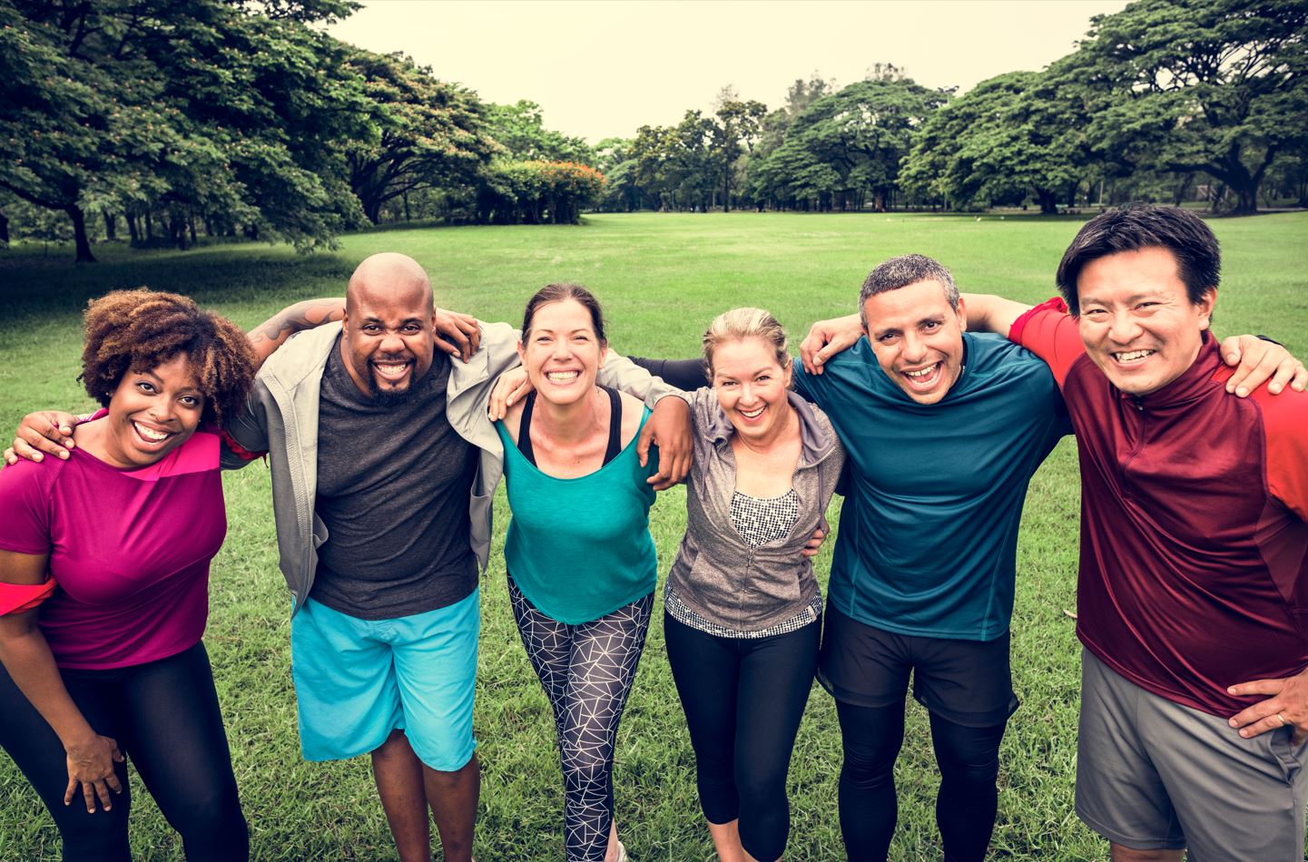 Group of people in sports clothes smiling at the camera