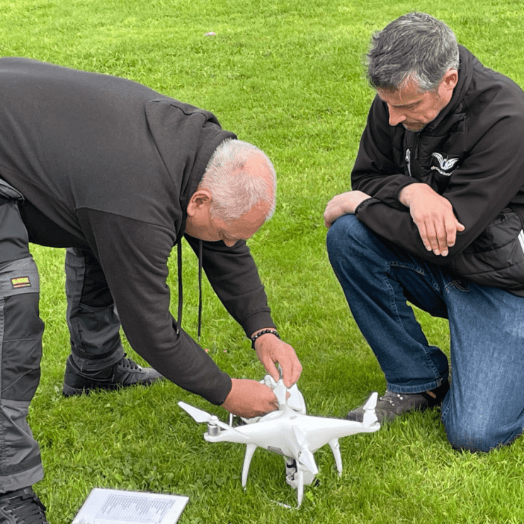 Julian Hoile With Global Drone Training Director Jonathan Carter Inspecting A Drone
