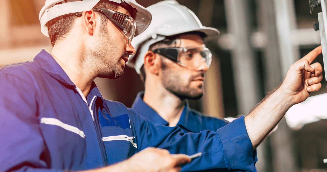 Training standards - Two Men In PPE Looking Inspecting Equipment