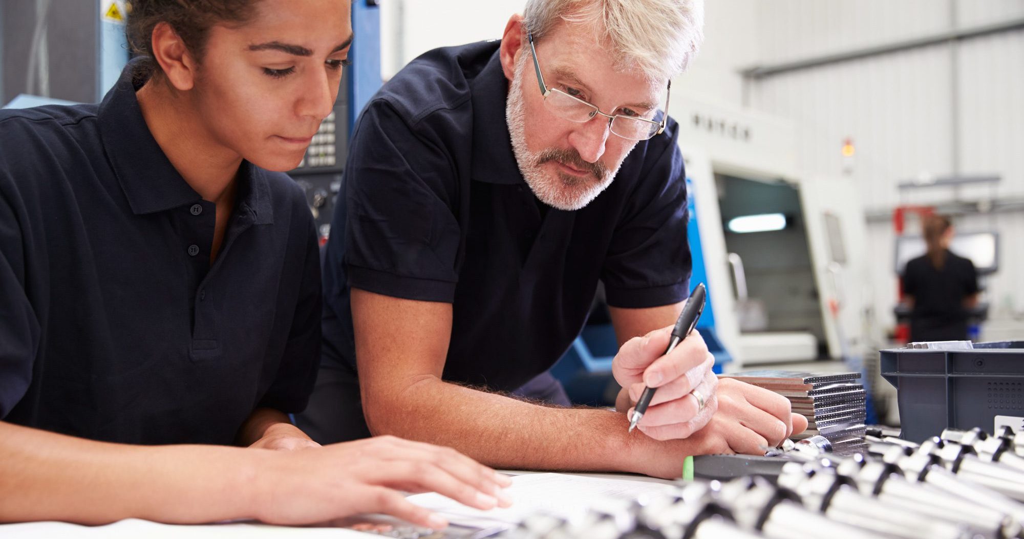 Engineer And Apprentice Planning CNC Machinery Project
